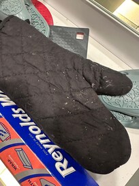 Oven mitts caked with food