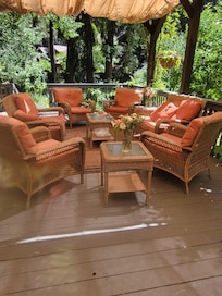 Seating for a large group up on the patio with fresh cut flowers
