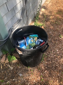 Full garbage can outside that smelled like dog feces.