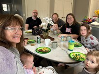 Enjoying dinner around the table.