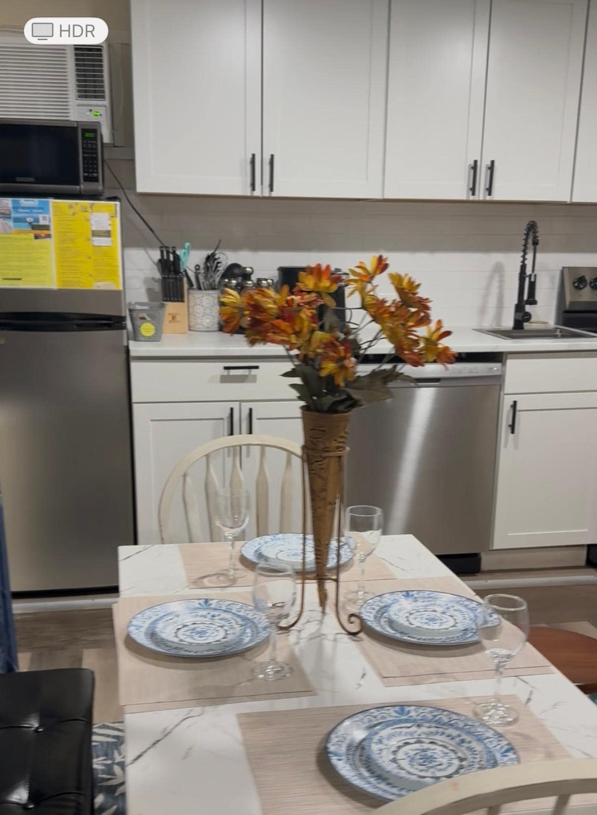 Kitchen with small fridge and small microwave (not the same as pictured in listing)