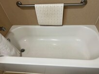 Shows brown scum in tub.
