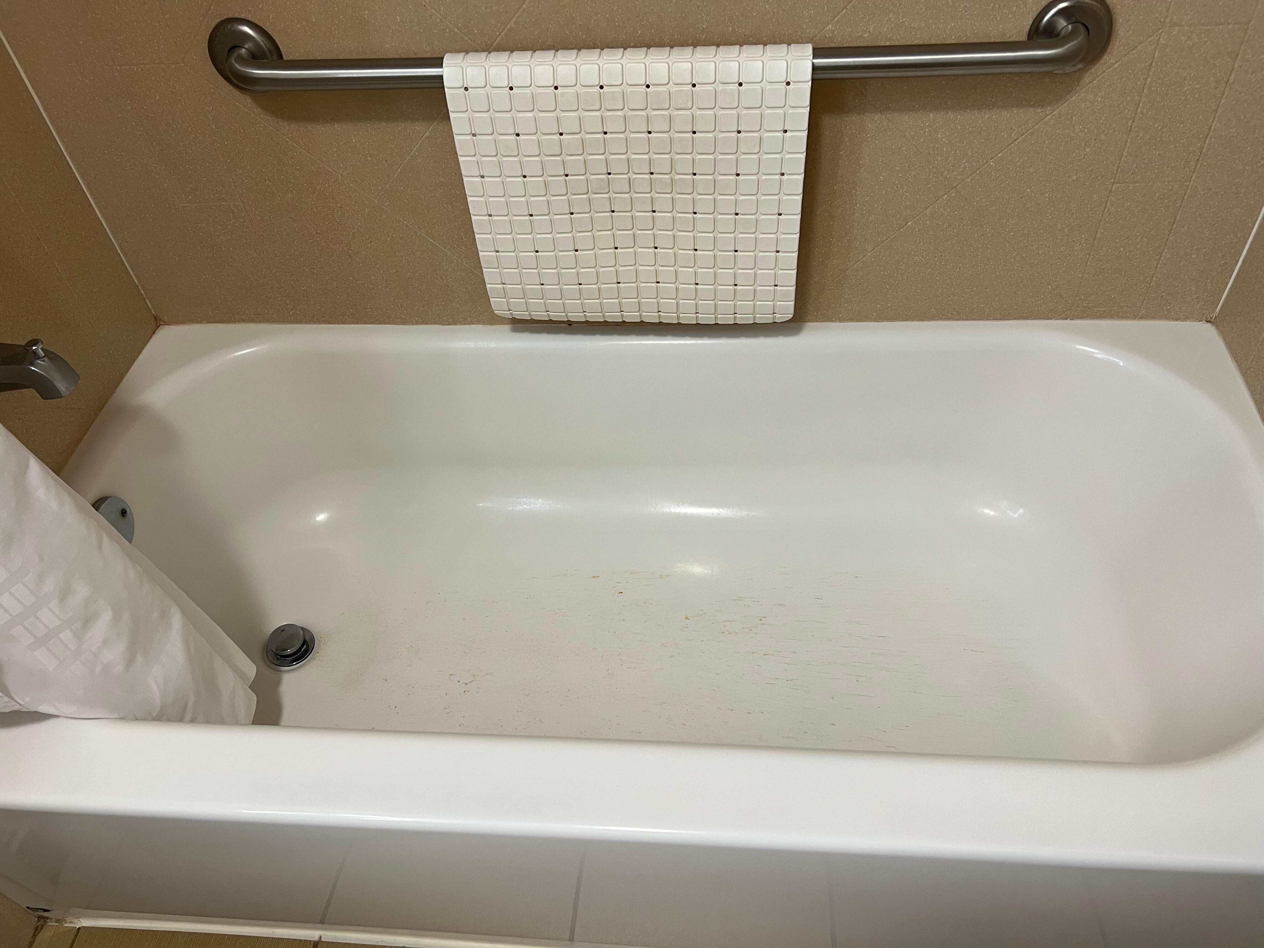 Shows brown scum in tub.