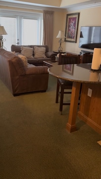 Living room ,kitchen to the right and dining room table to the left out of frame