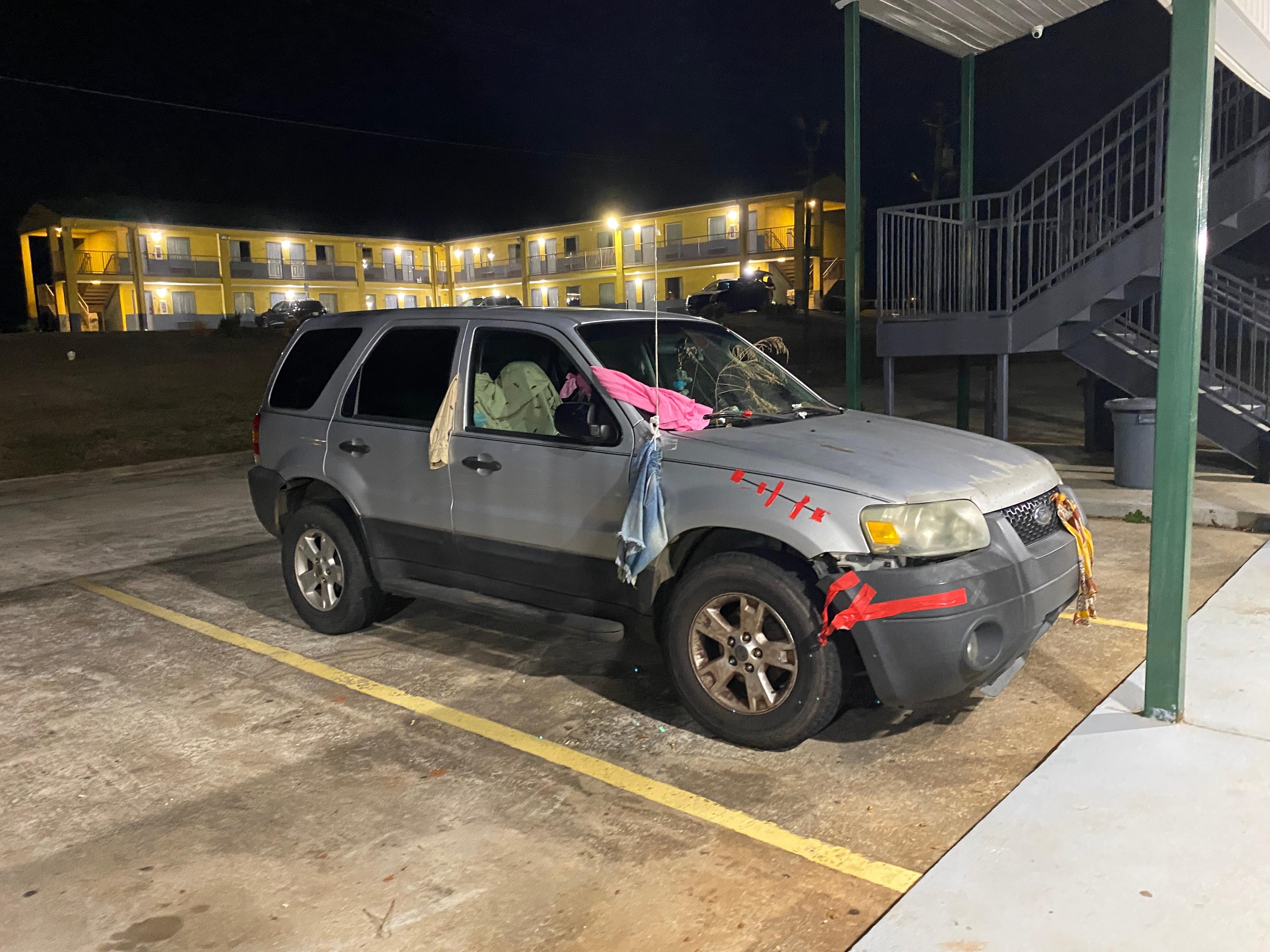 Car parked in front of rooms 
