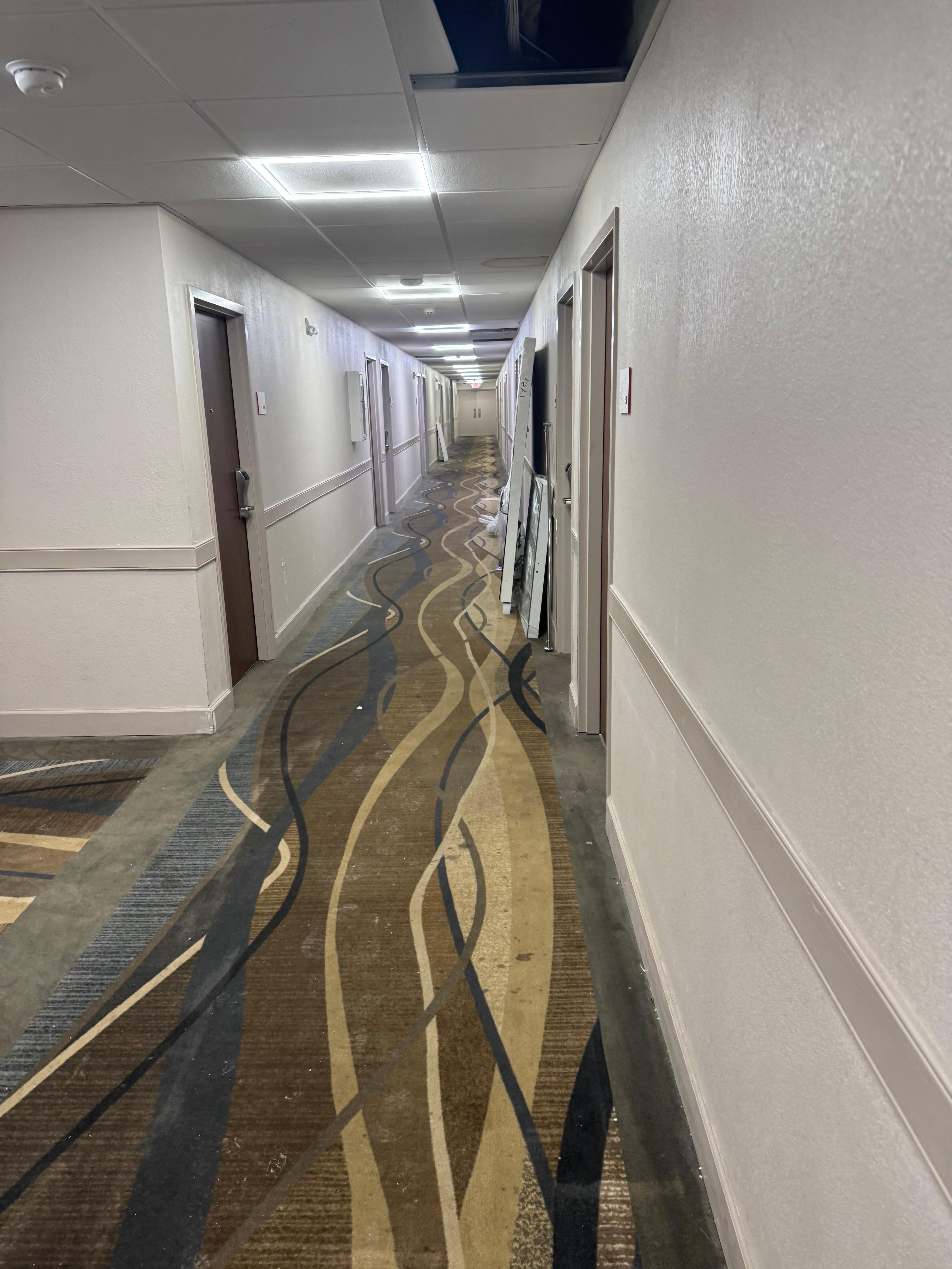 This doesn’t even come close to the rest of the hallways. Dirty and full of mirrors, shower doors and construction items. 