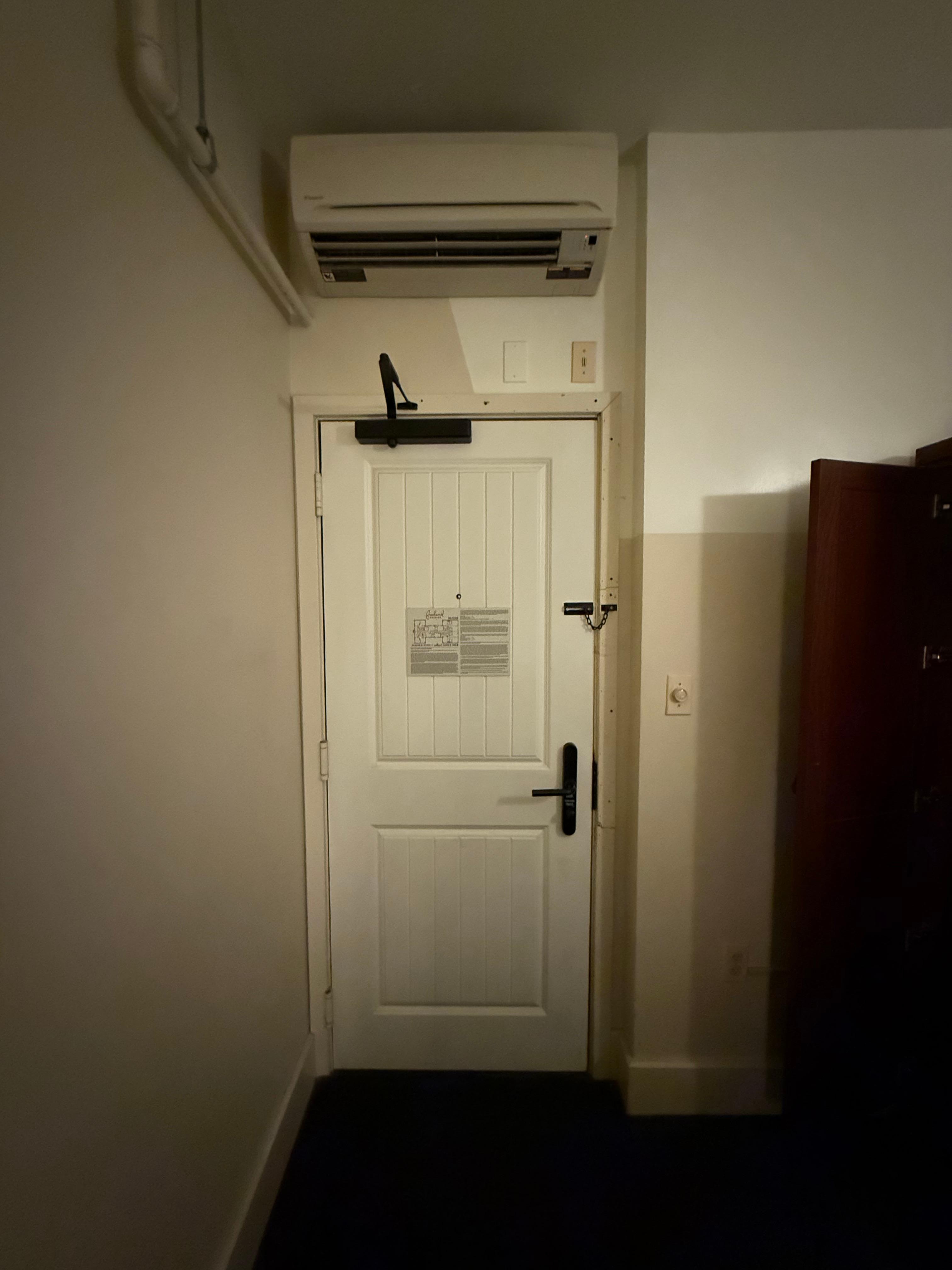 Disgusting AC unit over the door that blew out dust. This door had a weird lock and no deadbolt, just this thin chain. Didn’t feel very safe. 
