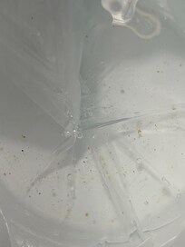 Melted ice in the liner inside of the ice bucket.