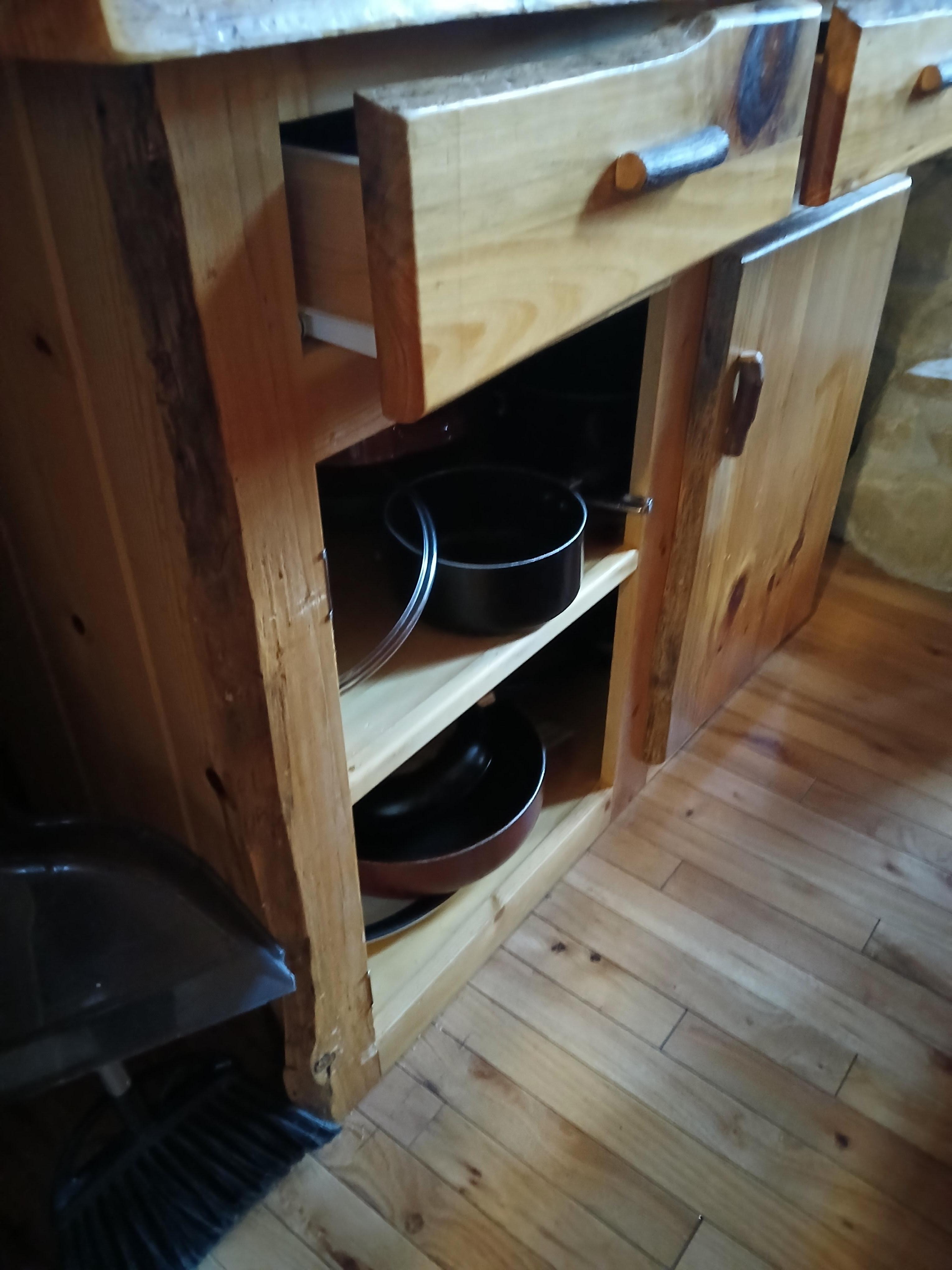 Cabinet door broken off and sitting beside cabinet