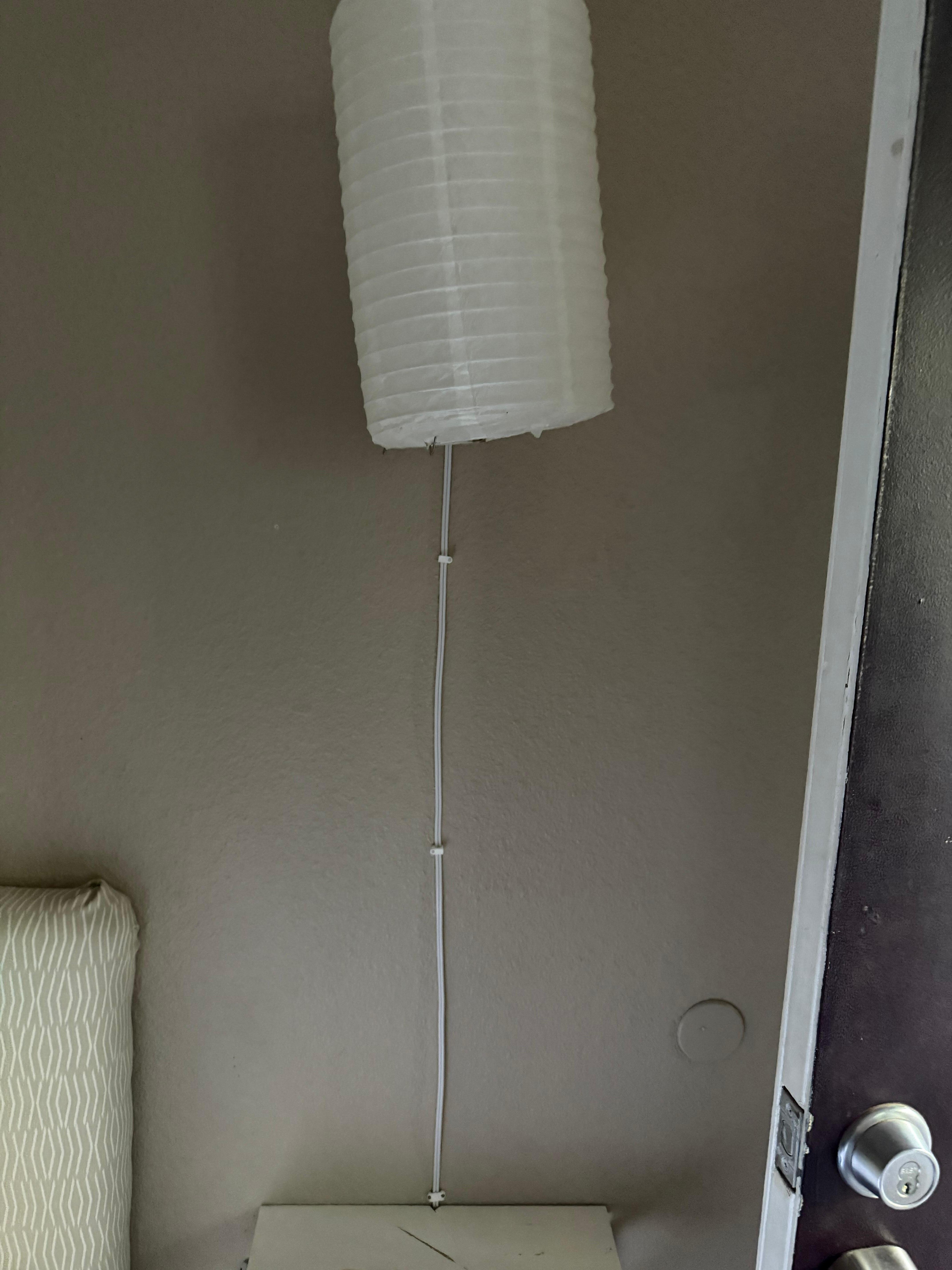 Paper lighting fixture stapled to the wall - no hard fixtures as posted on the website 