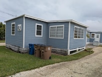 Street view with entrance to property in back.