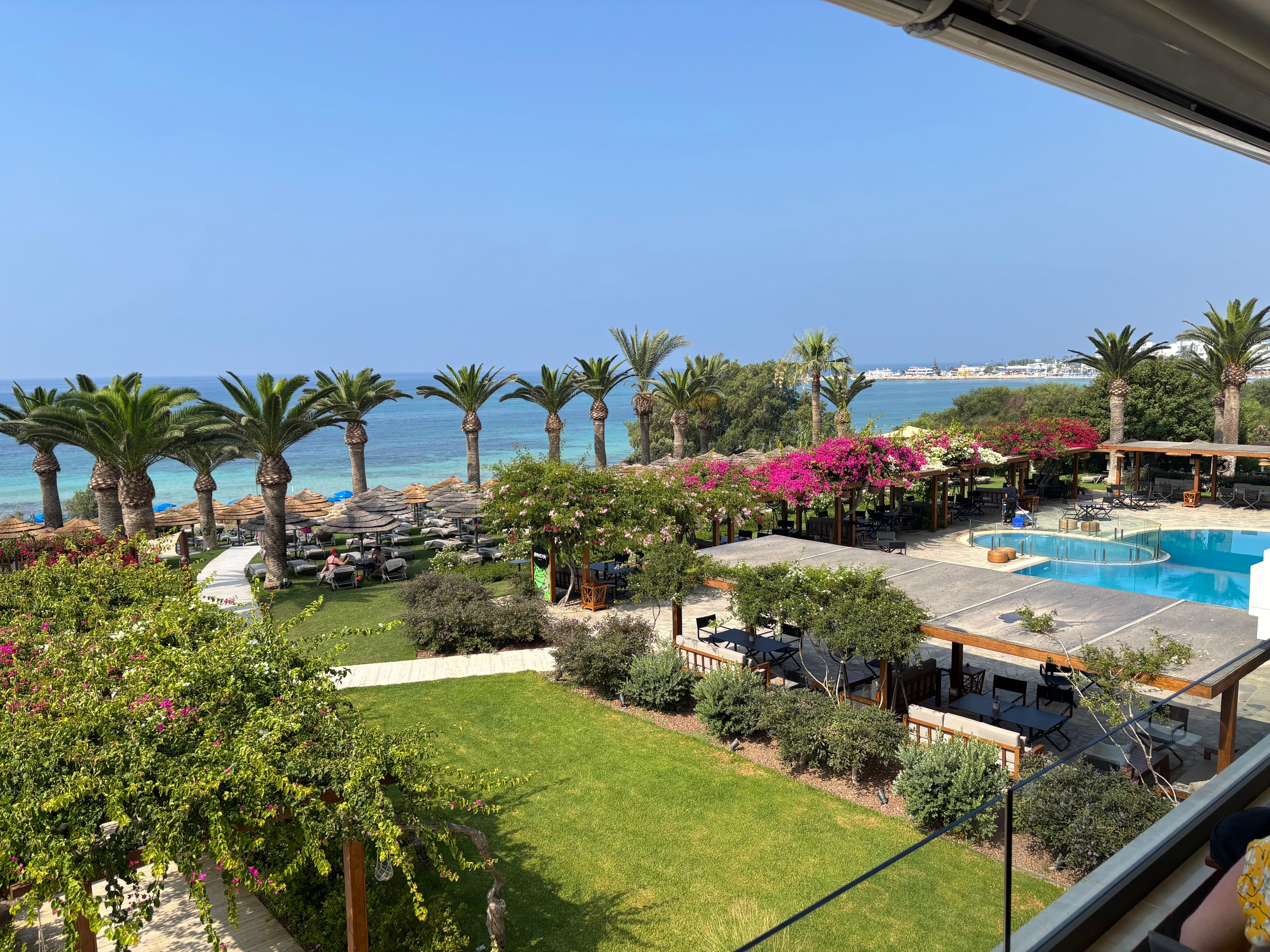 Beautiful gardens leading down to sandy beach and turquoise Mediterranean