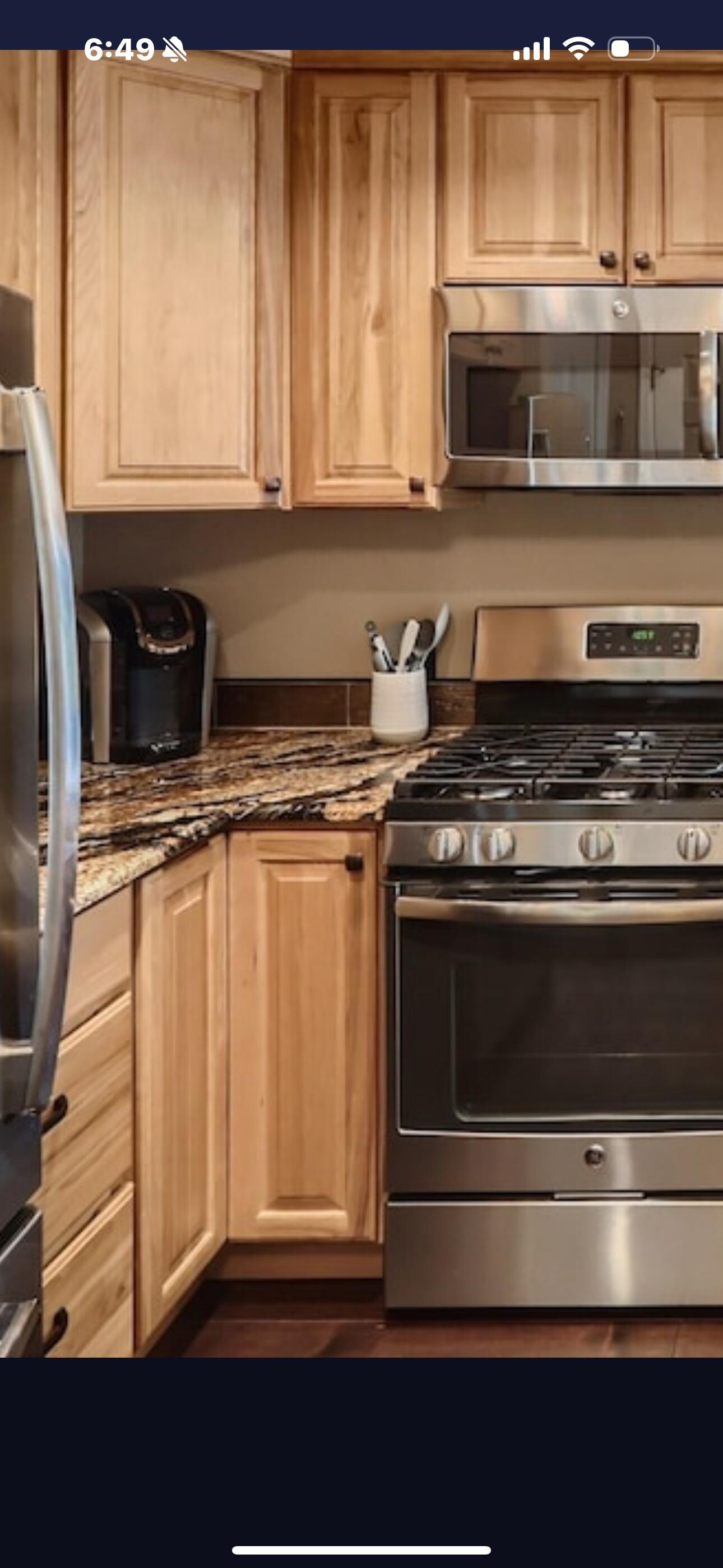 Ad for condo kitchen showing Keurig coffee maker.