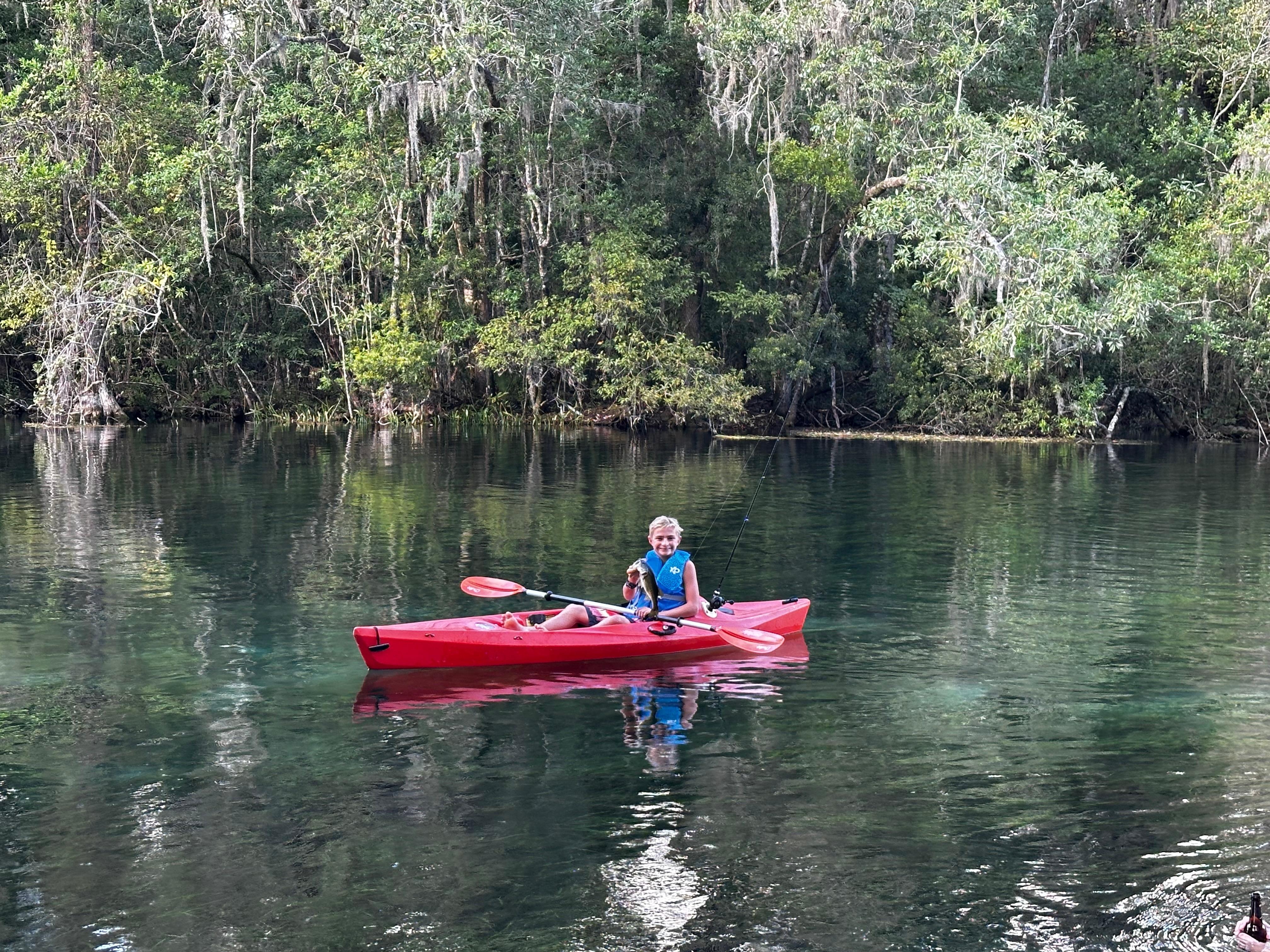 My son fishing right off the backyard bank catching bass.