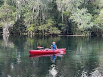 My son fishing right off the backyard bank catching bass.