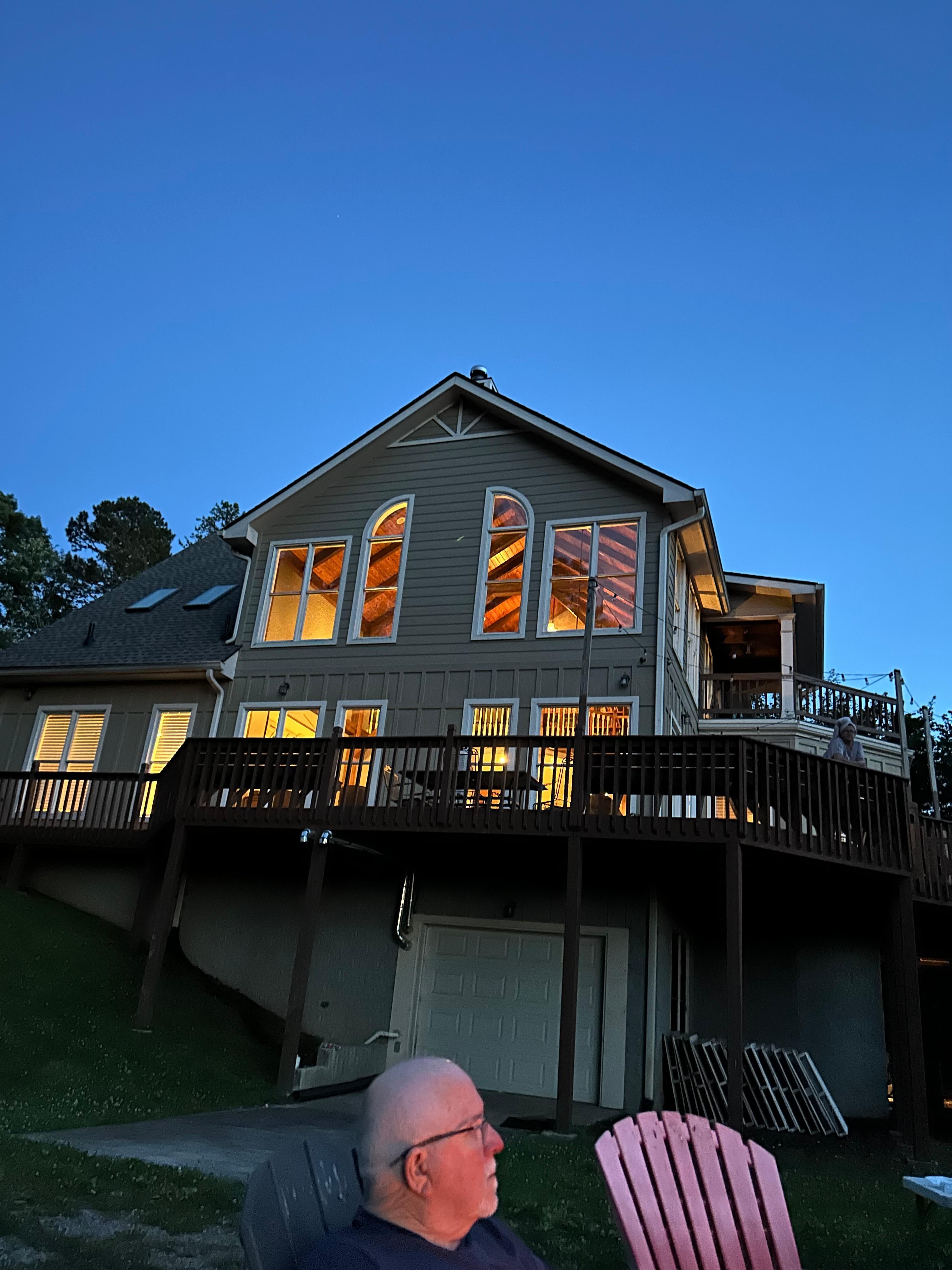 The house at night taken from fire pit