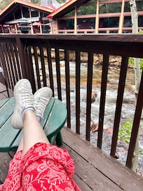 Patio adjacent to river with restaurant in background