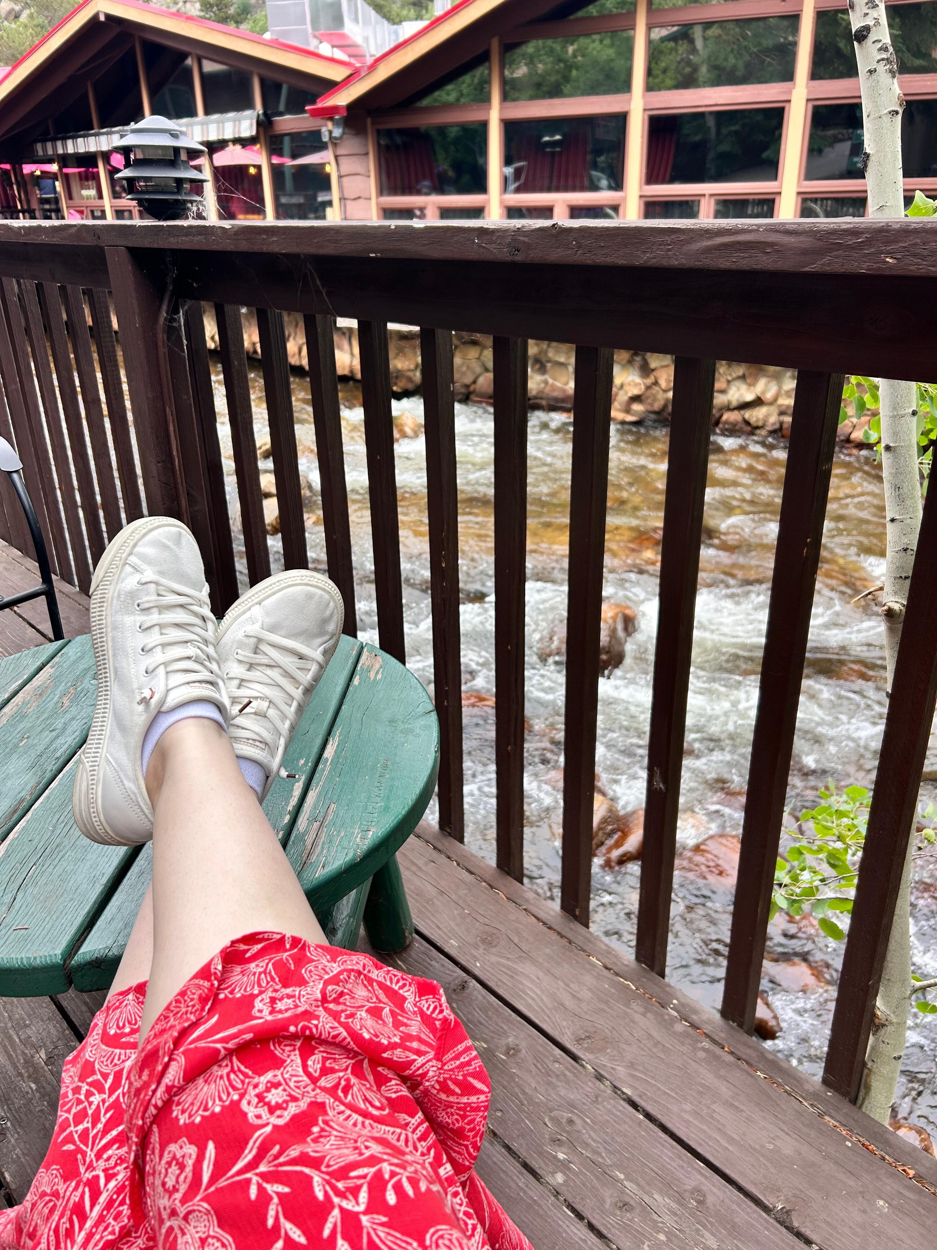 Patio adjacent to river with restaurant in background