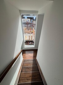 Stair has no curtains and at seven am the construction workers wave to you