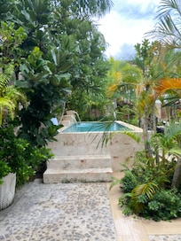 Splash pool steps from room with waterfalls.