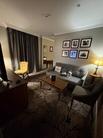 Left side tv & fridge in desk with nice chair