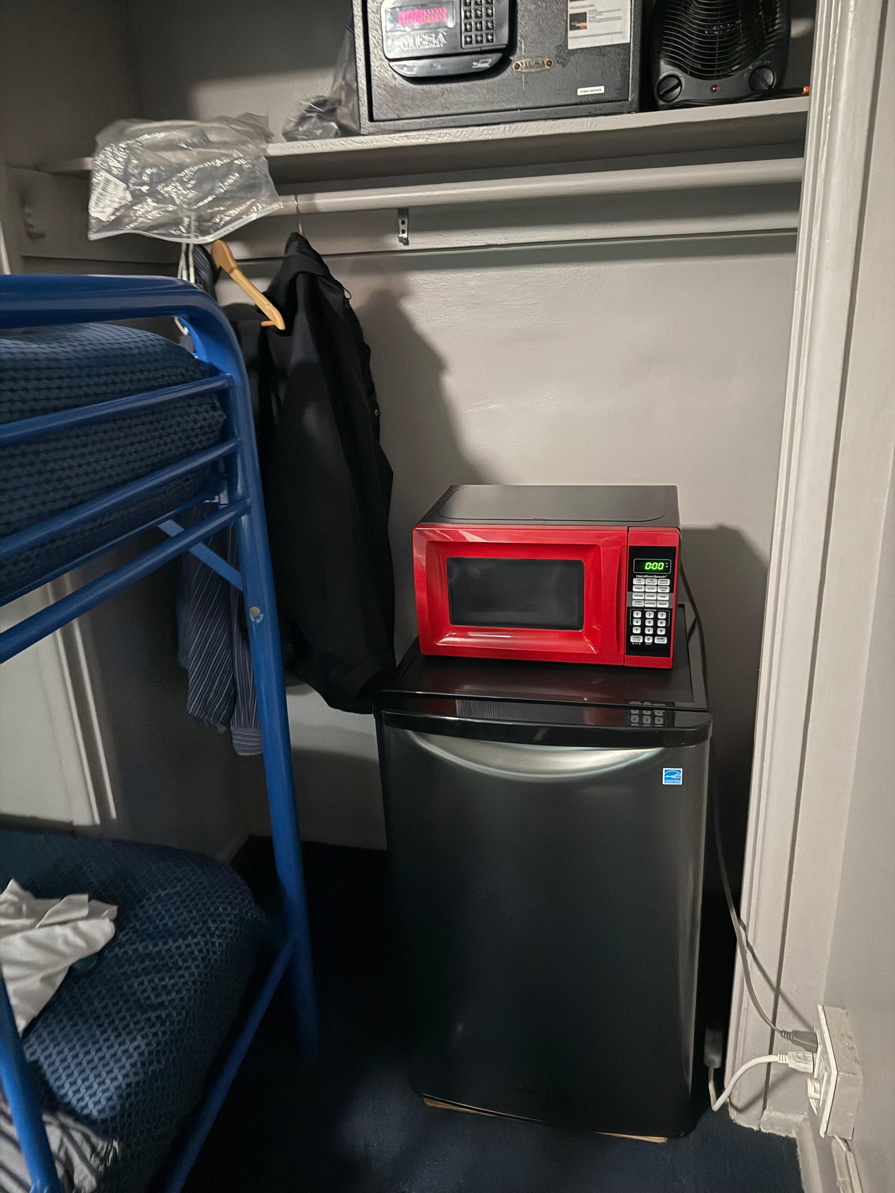 closet blocked by unwanted bunk bed, fridge, microwave. no drawers, table, flimsy nightstand 