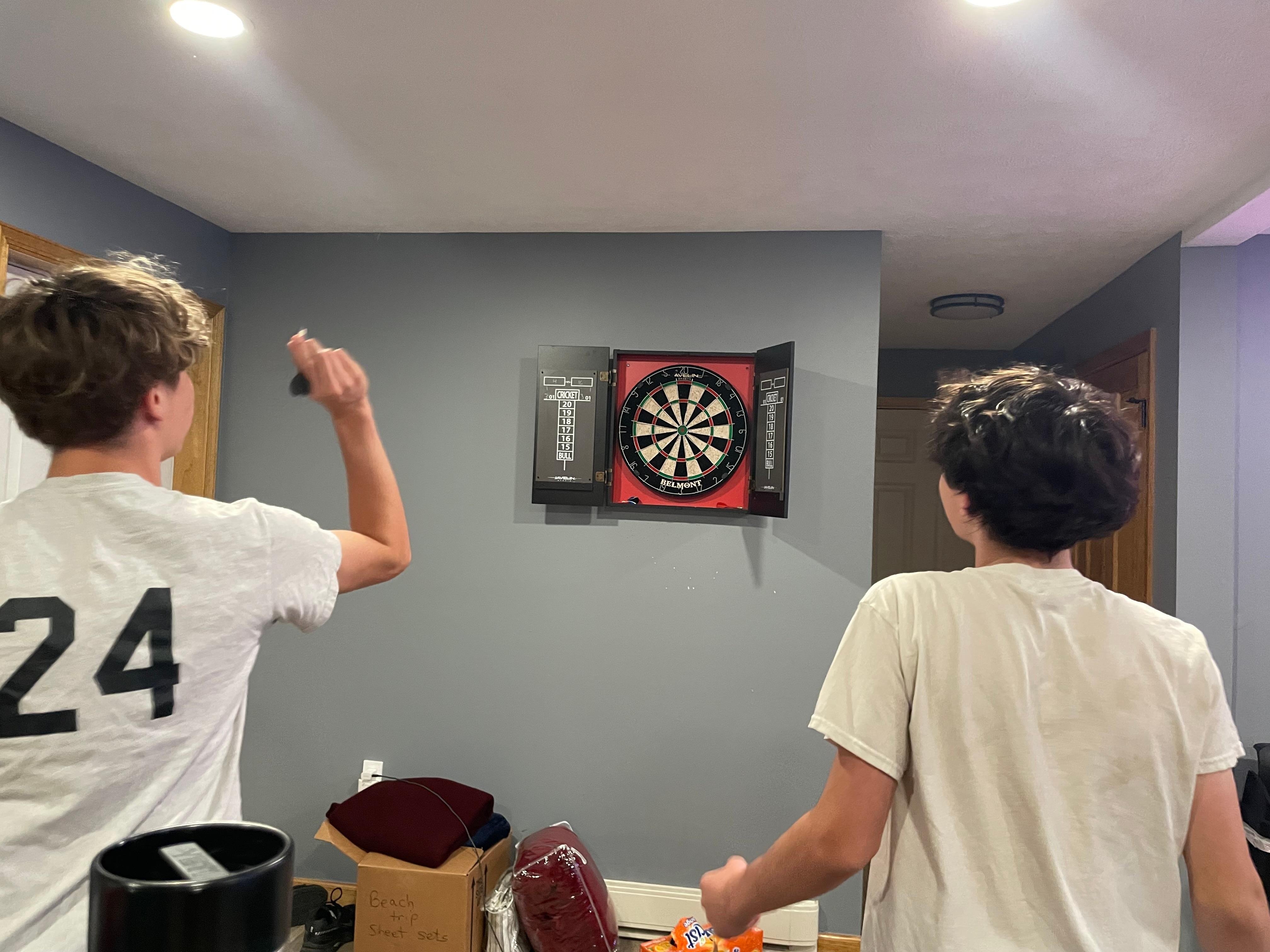The boys giving darts a try ! 