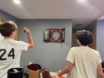 The boys giving darts a try !