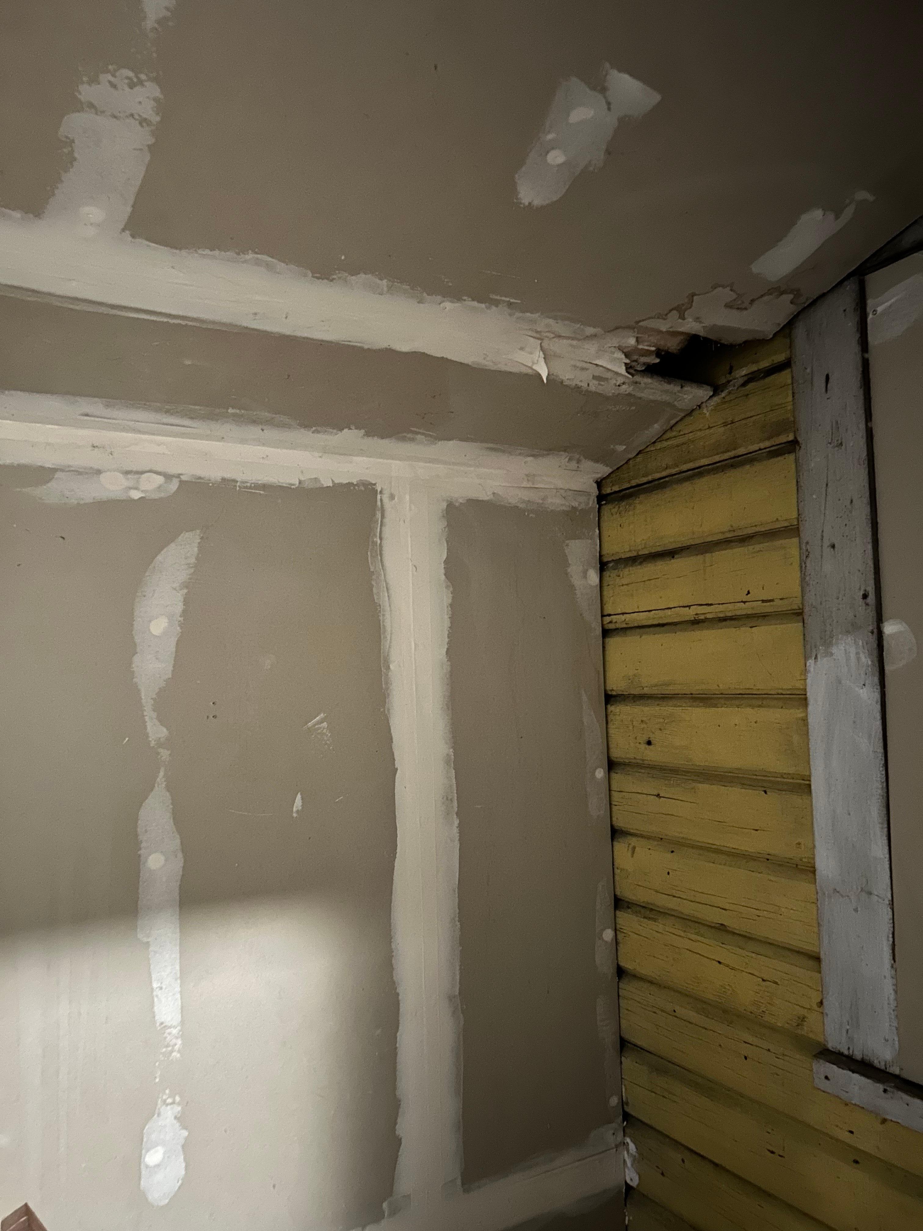 Unfinished paint and hole in laundry area