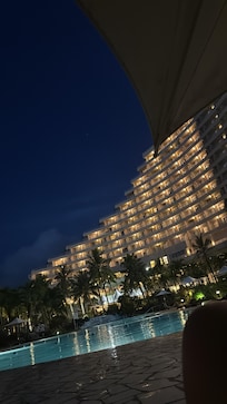 View of the hotel from the poolside at night.