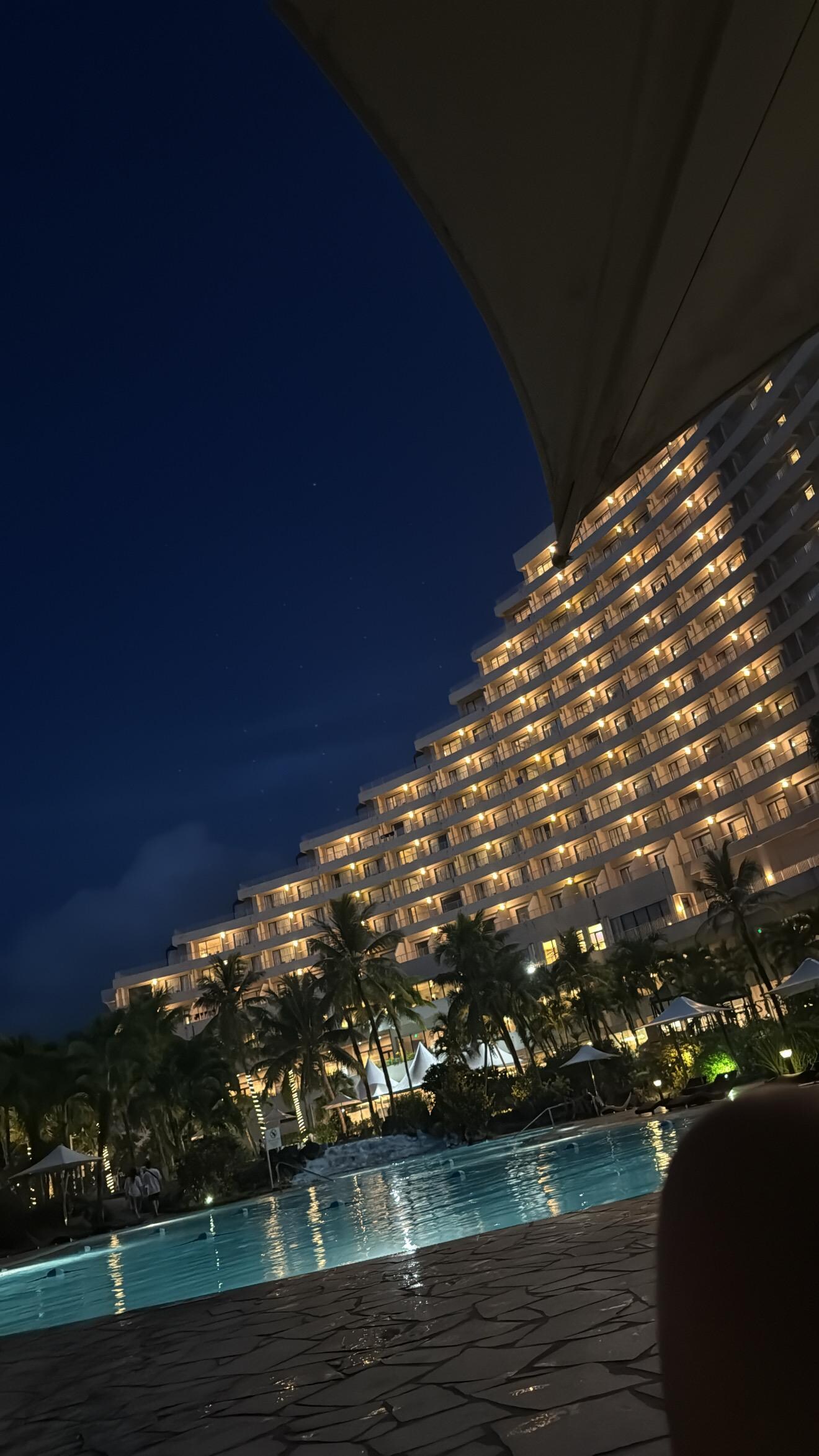 View of the hotel from the poolside at night. 