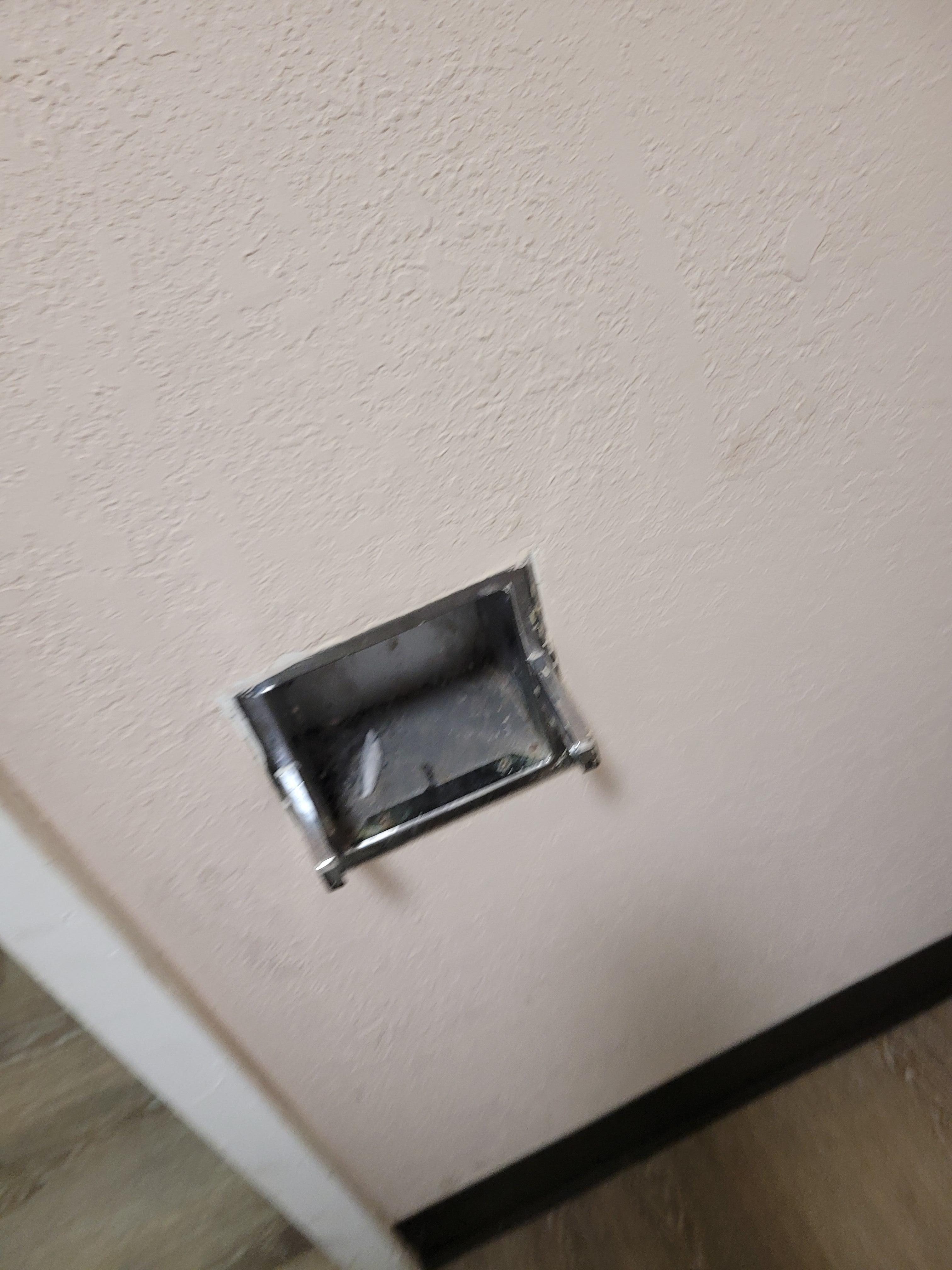 Dirty broken toilet paper holder. Whats in it?