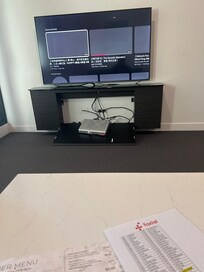 underneath TV broken and couch filthy