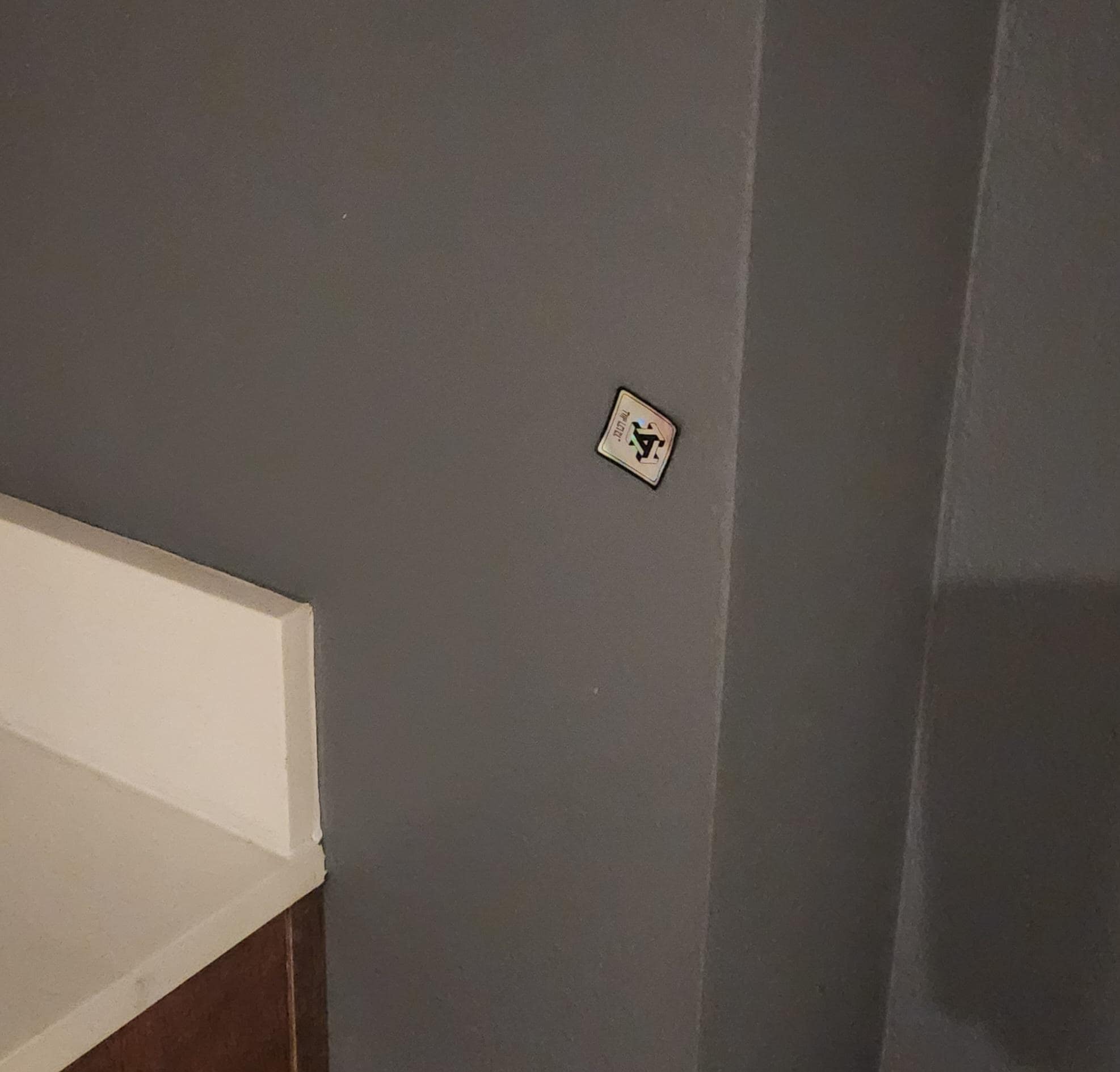 Random sticker on the wall in the bathroom