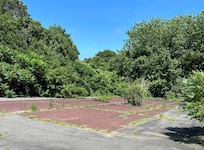 We were told that the tennis court had some cracks in the surface and we could use it at our own risk. There were bushes growing on it.