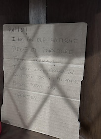 Host's note for broken glass front on cabinet
