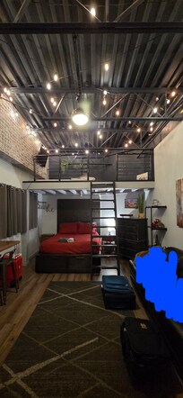 The room when we arrived - it was perfect, as good or better than we expected (blurred out my kid laying on the couch).