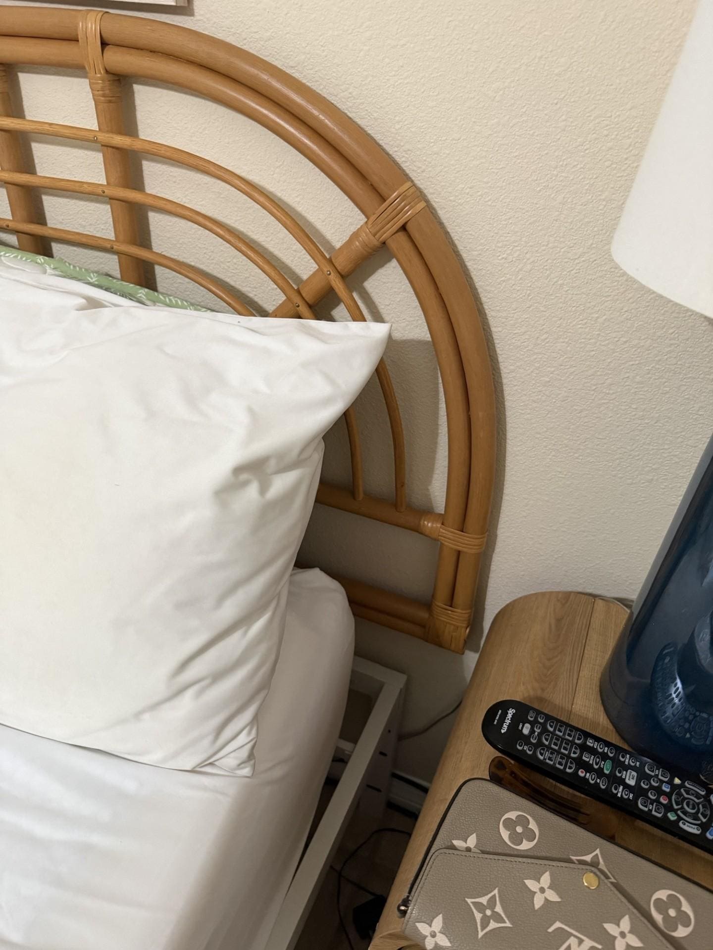 Headboard not attached to bed, hung up to the wall by a screw.