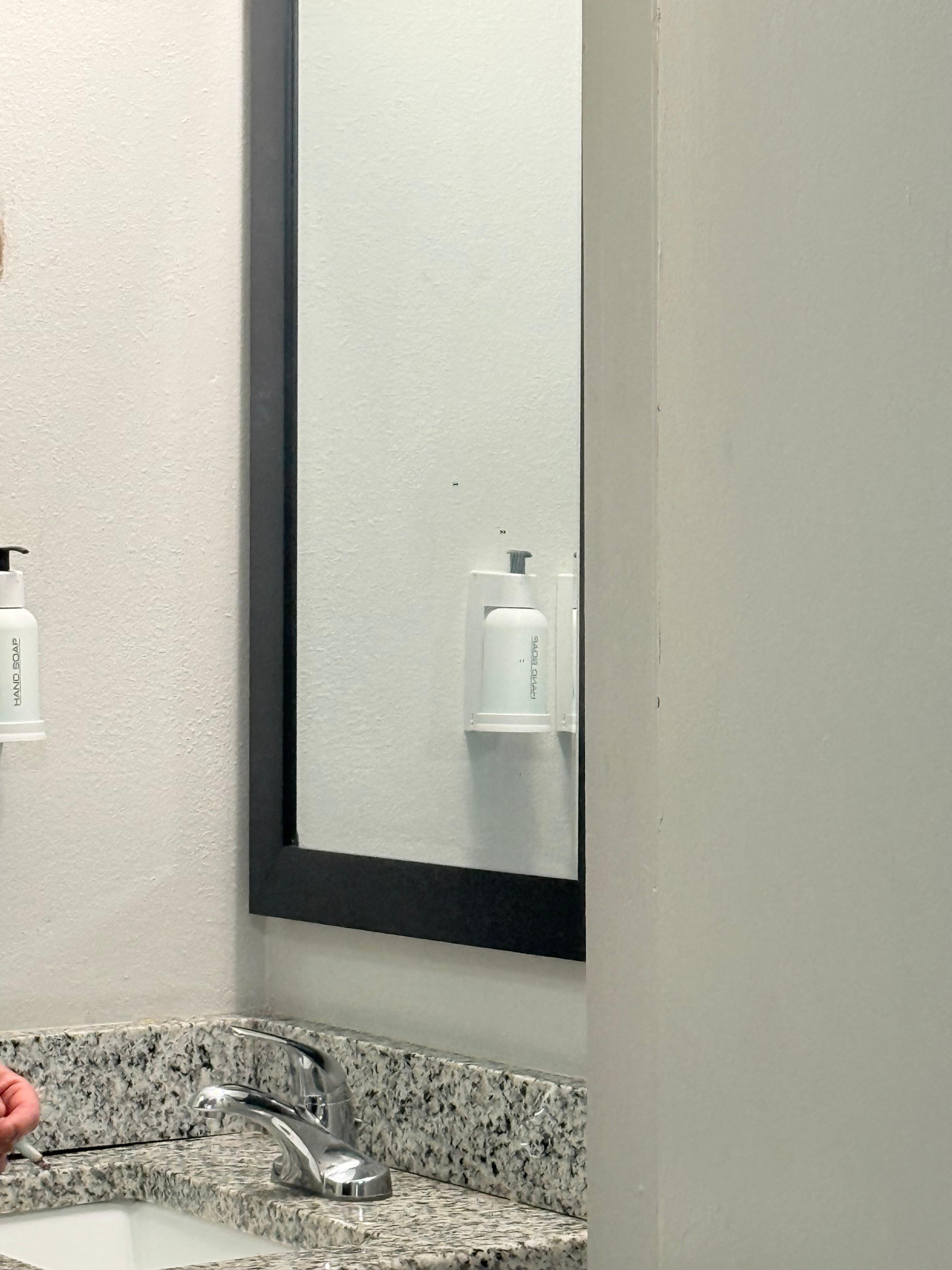 Black stains on mirror 