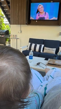 baby enjoying the porch swing & outdoor tv