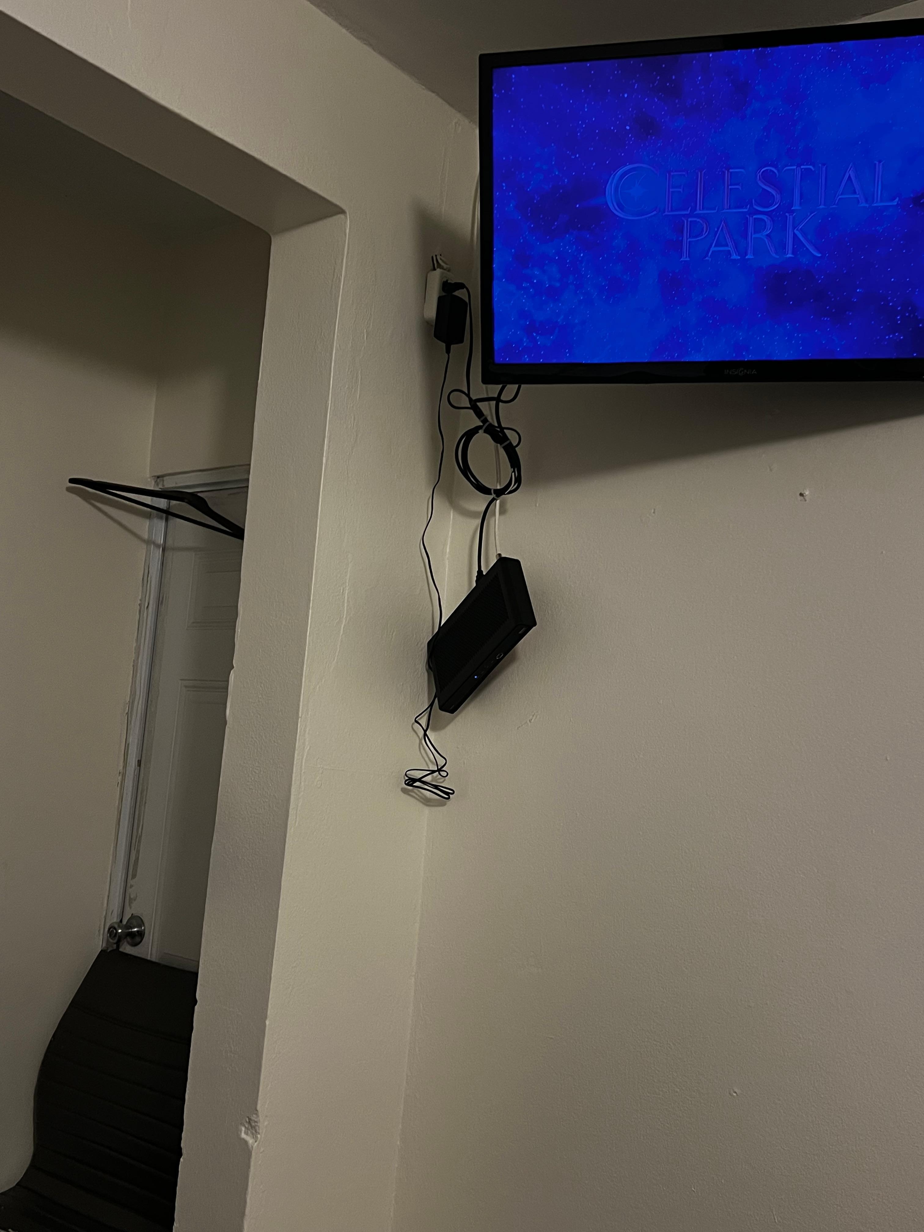 Cable box hanging, loose wires.