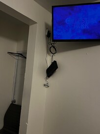 Cable box hanging, loose wires.