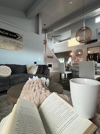 Coffee and a book next to the fireplace.