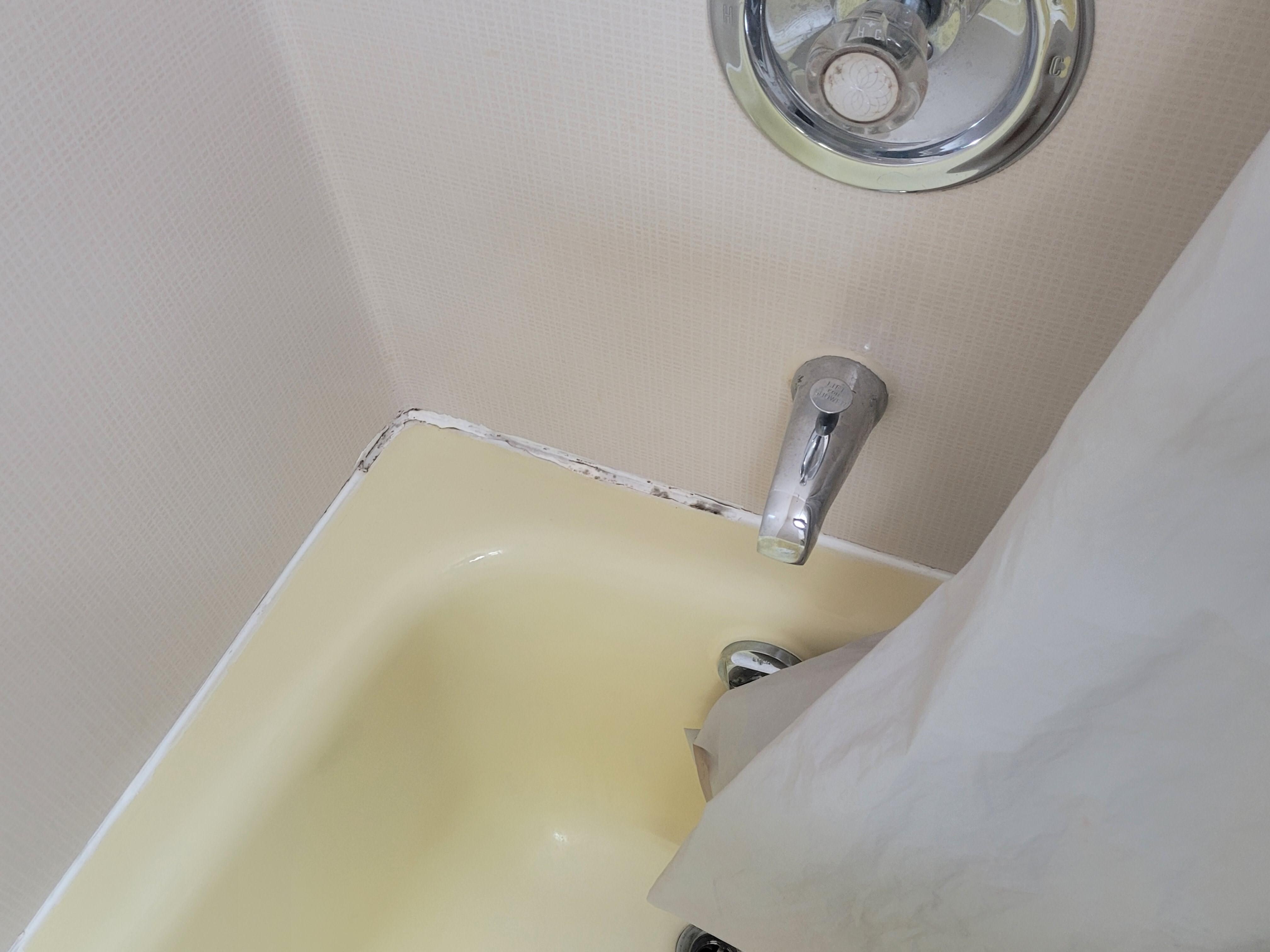 Tub in poor condition & caulking off around wall and tub