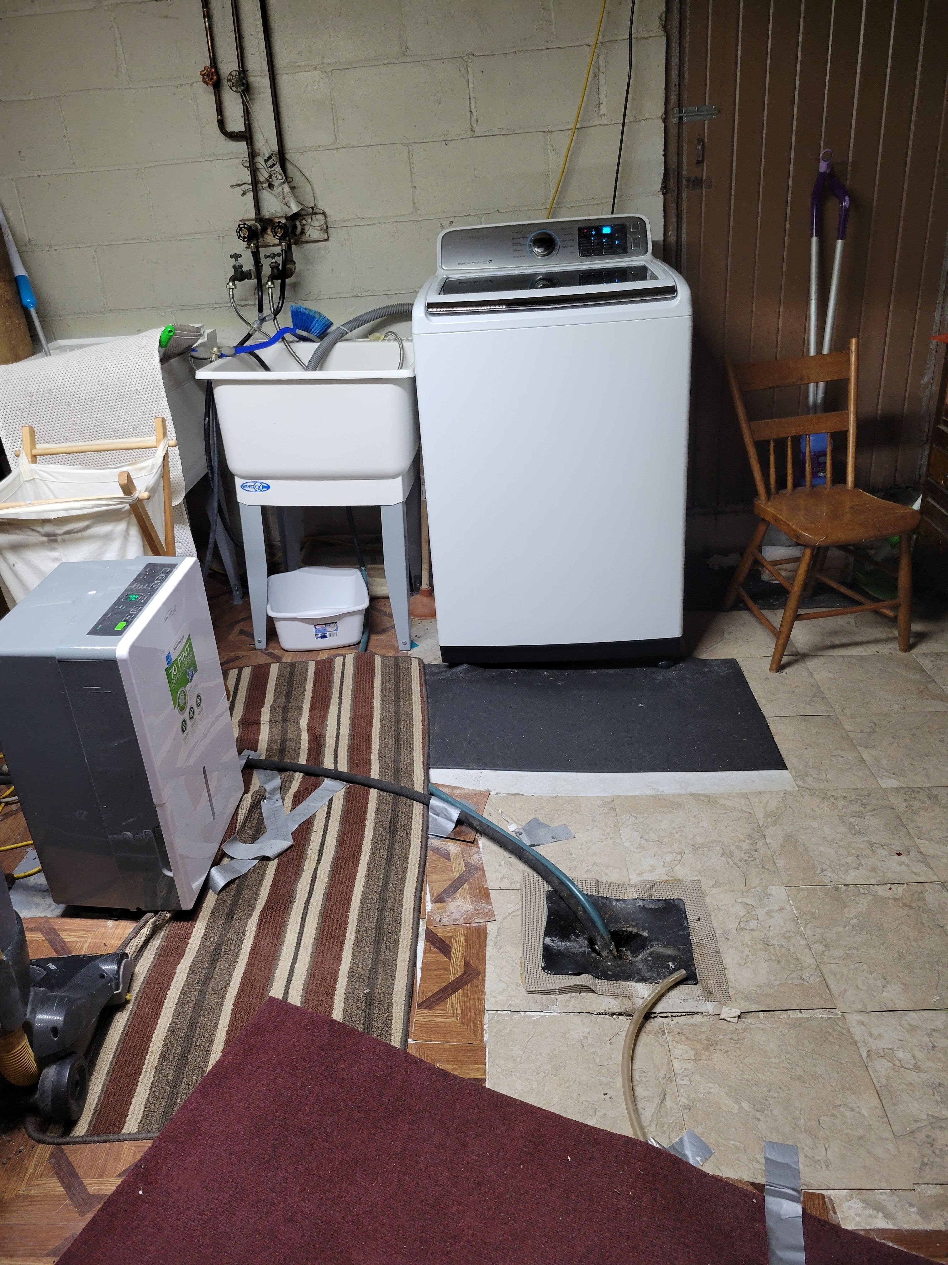 Washer, don't trip over hoses to the floor drain!
Dryer around the corner,  watch your head on low ceiling. 