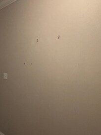 Screws or nails on the walls were pictures previously hung.