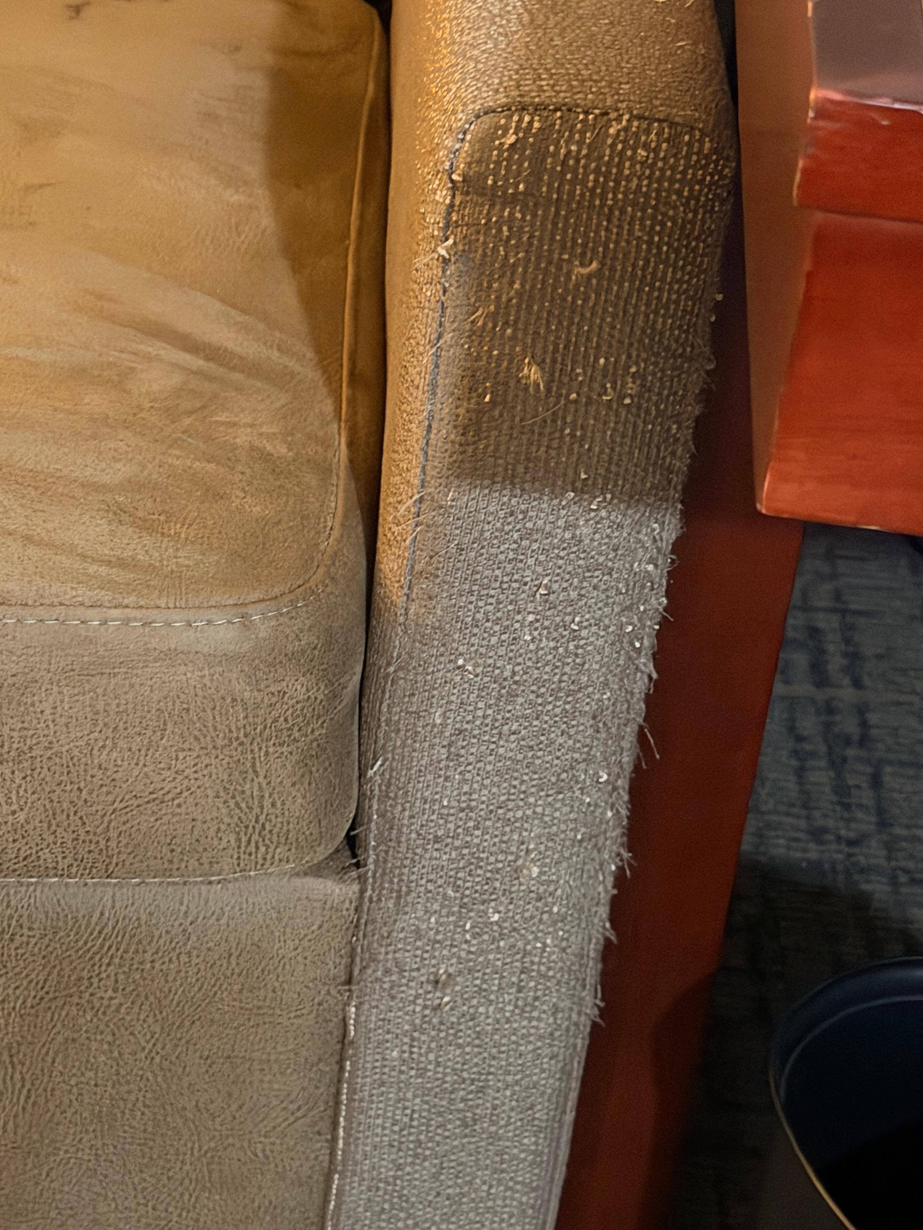 It looks like an animal used the sofa as a scratch post