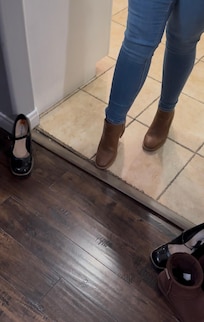 Broken transition strip separating the kitchen and dining room.