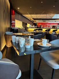 Filthy crockery stacked on a table right beside the table we were taken to eat breakfast