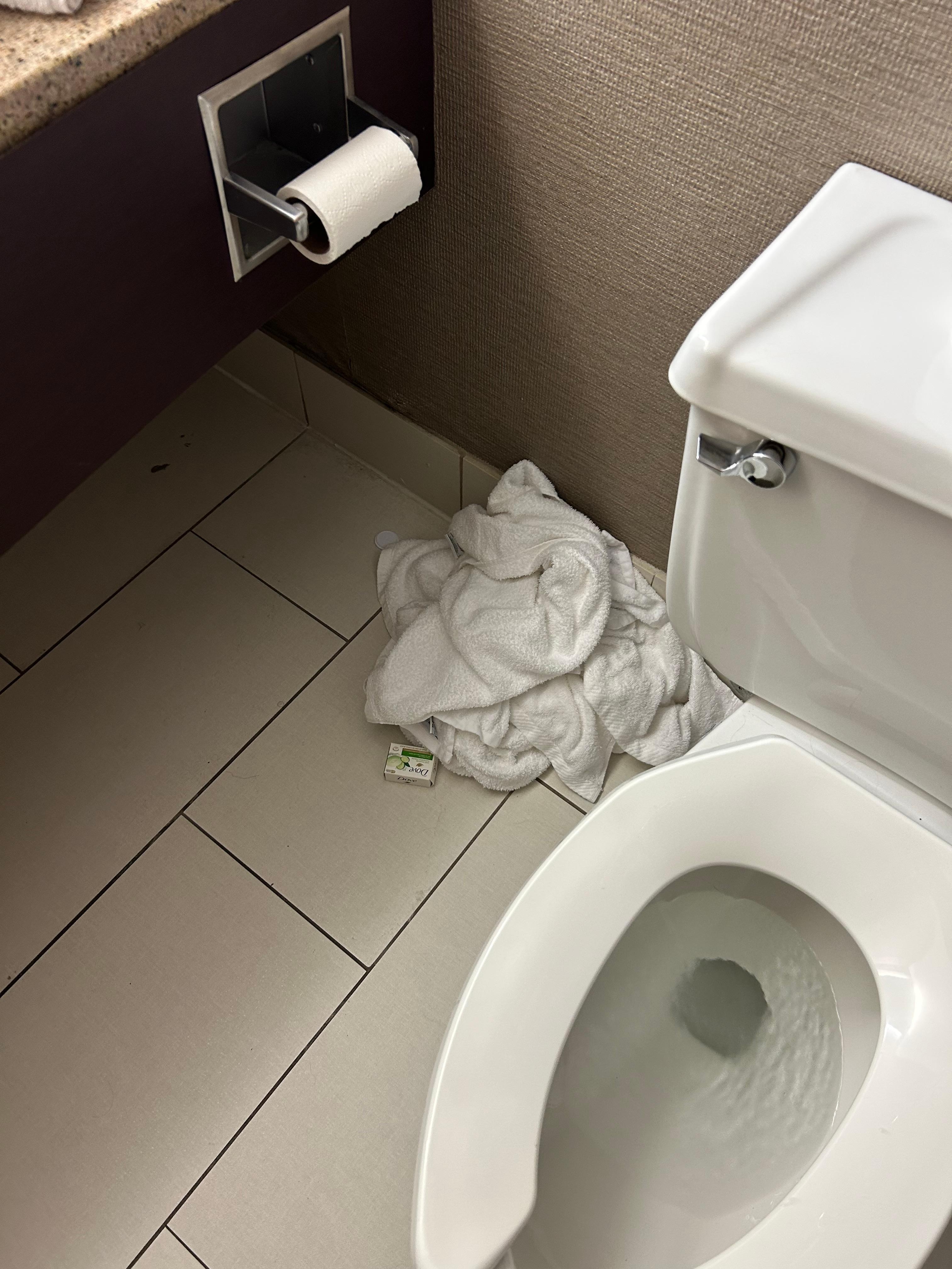 One pile of dirty towels left for us to remove next to the constantly running toilet.
